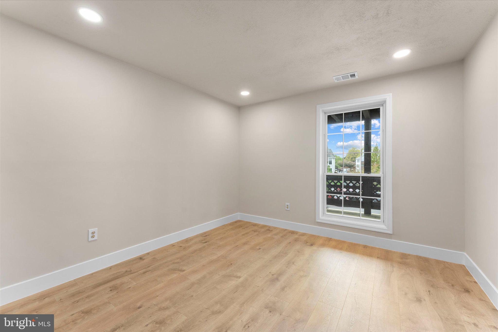 10066 Oakton Terrace Road, Unit 10066 Oakton, VA 22124 - Photo 17 of 27 an empty room with windows
