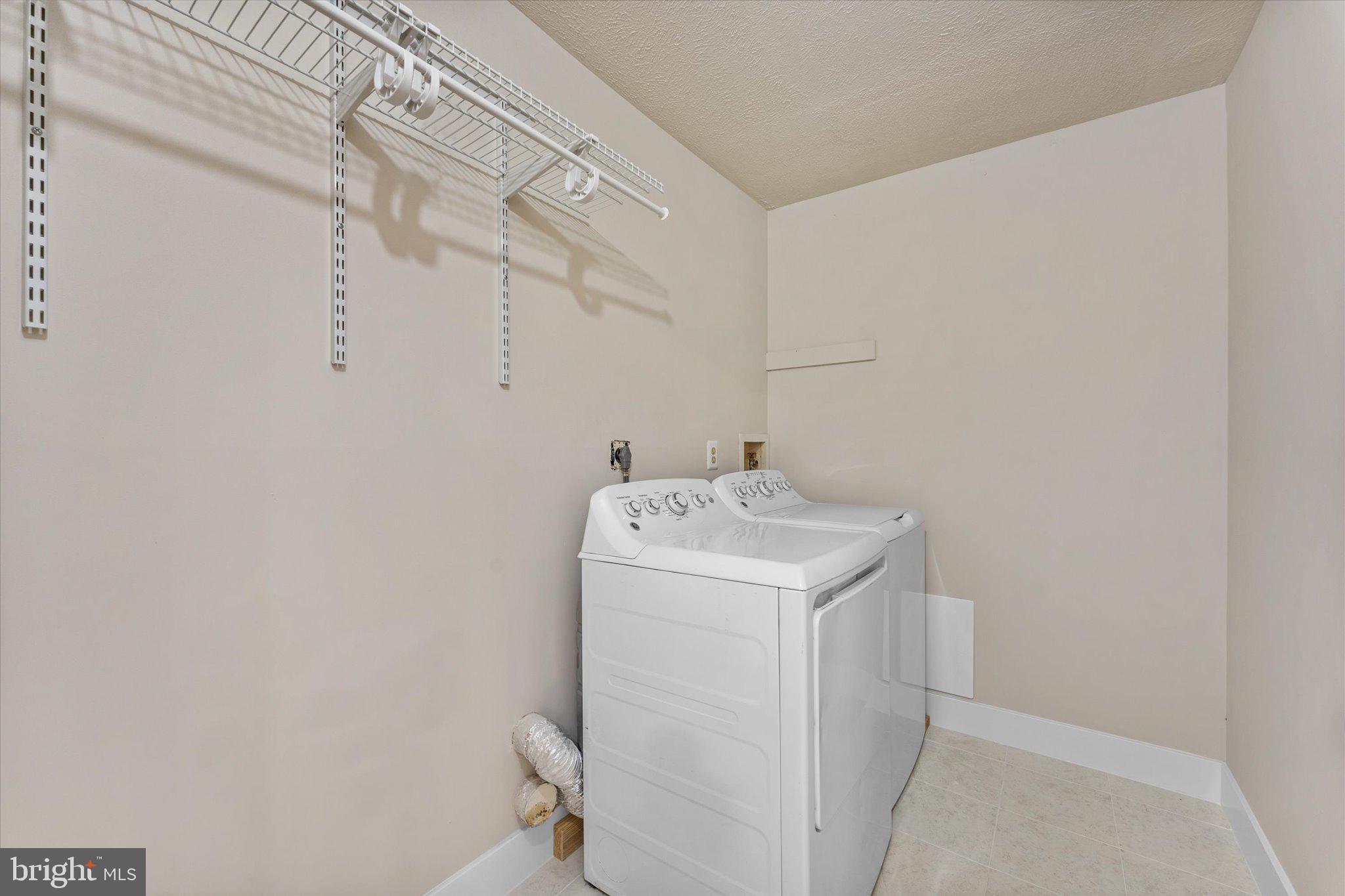10066 Oakton Terrace Road, Unit 10066 Oakton, VA 22124 - Photo 22 of 27 a utility room with dryer and washer