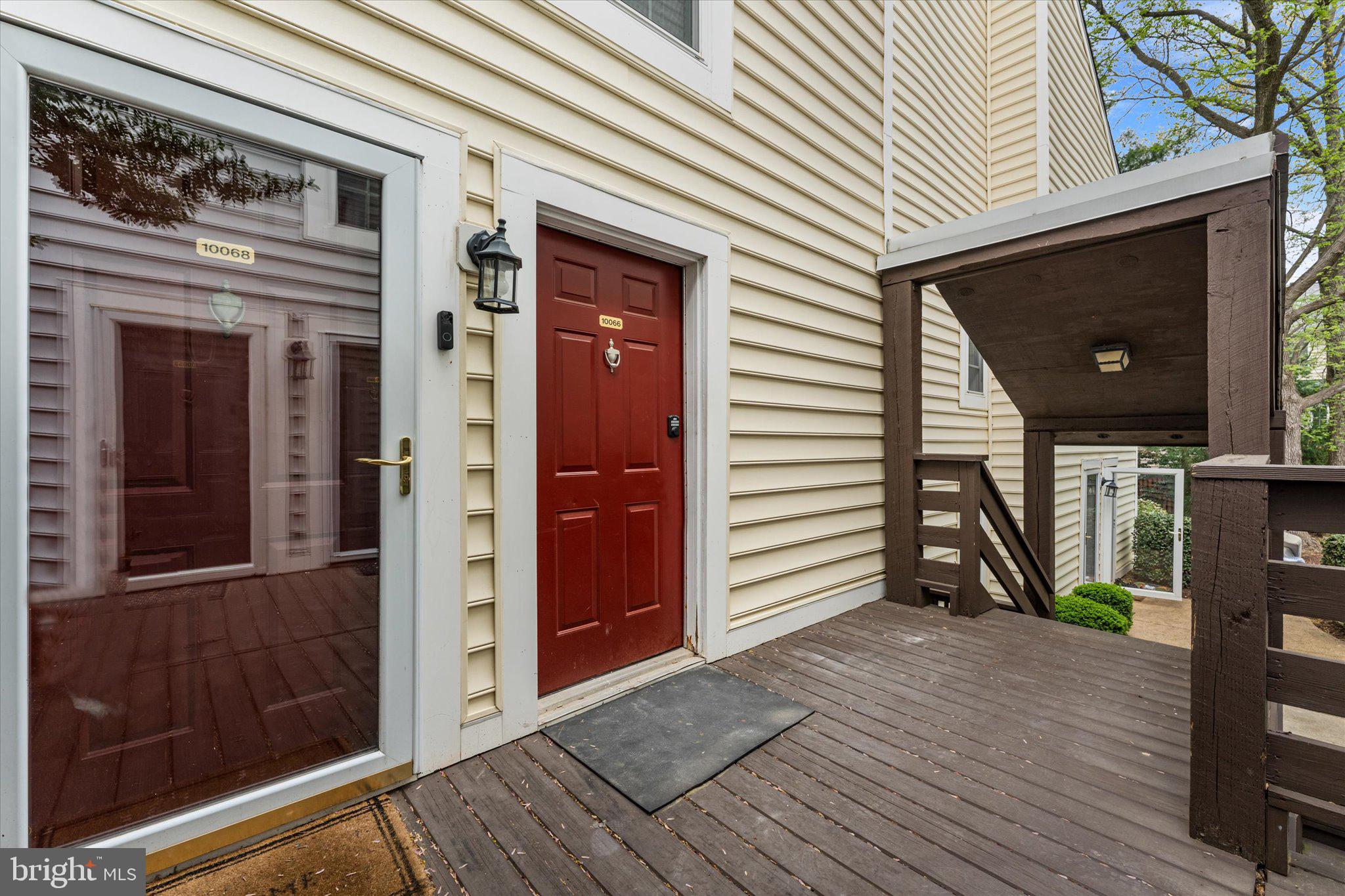 10066 Oakton Terrace Road, Unit 10066 Oakton, VA 22124 - Photo 23 of 27 a view of a porch with wooden floor and a fireplace