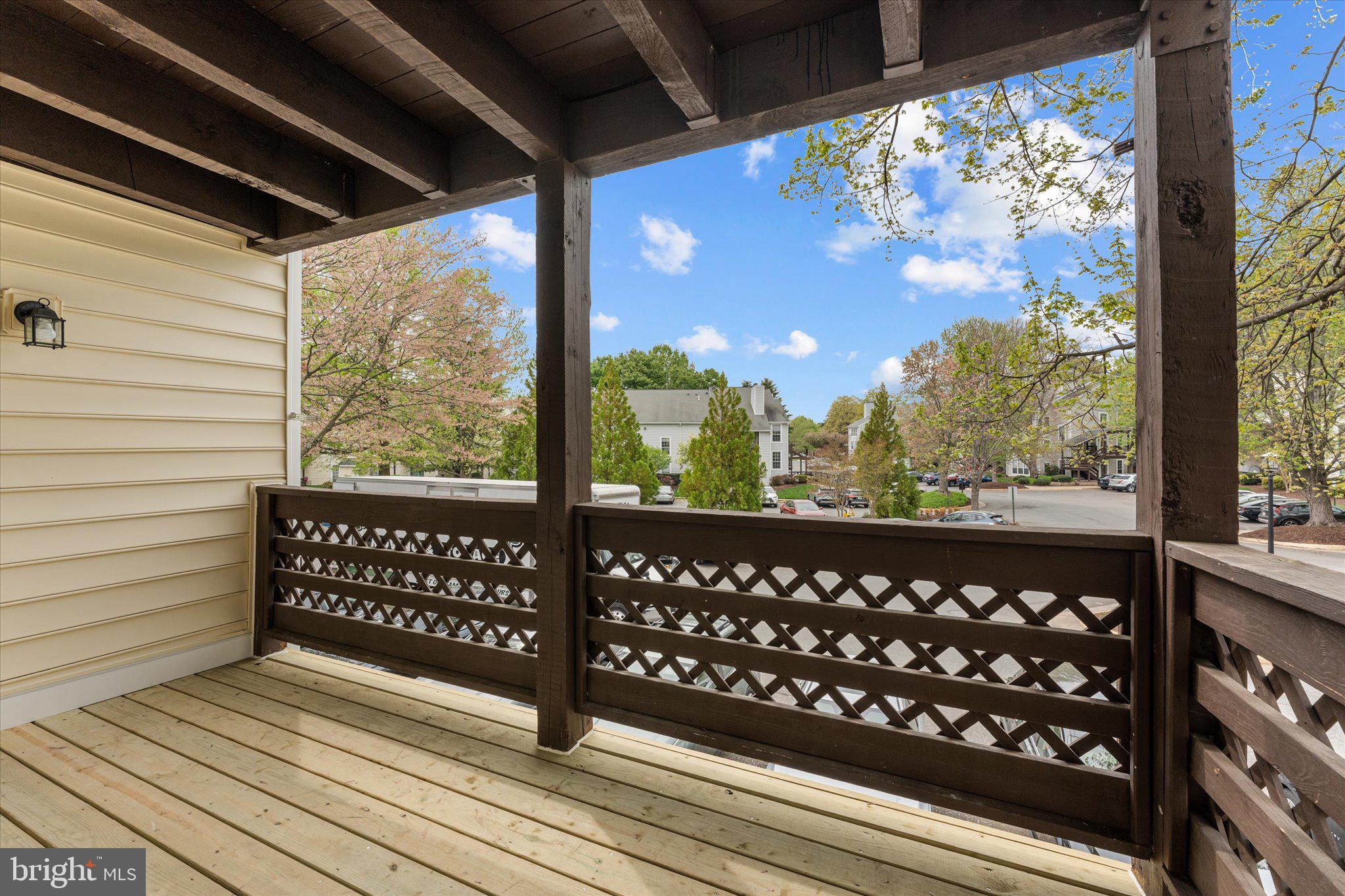 10066 Oakton Terrace Road, Unit 10066 Oakton, VA 22124 - Photo 27 of 27 a view of a wooden bench next to a yard