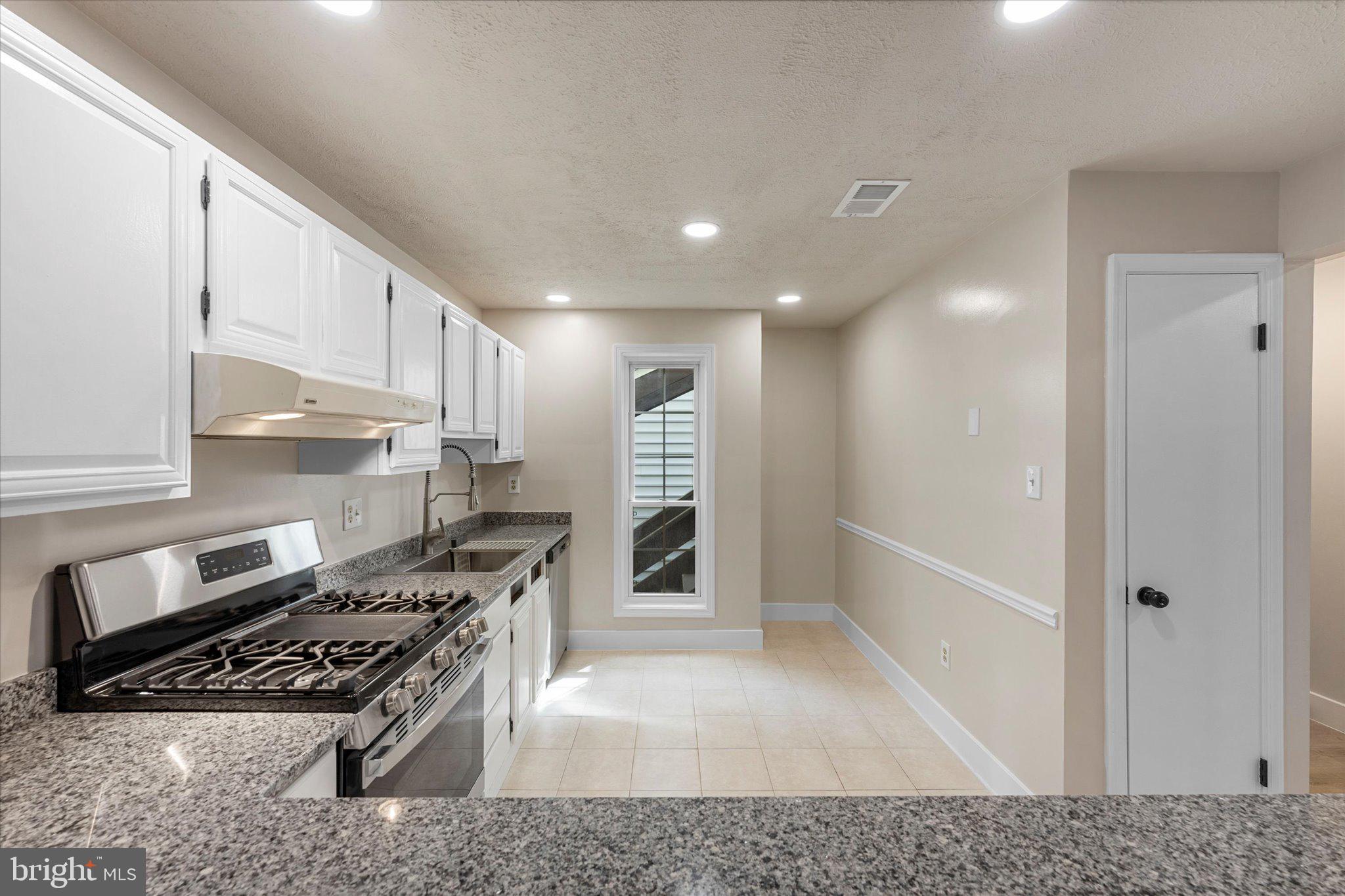 10066 Oakton Terrace Road, Unit 10066 Oakton, VA 22124 - Photo 10 of 27 a kitchen with stainless steel appliances granite countertop a refrigerator and a stove