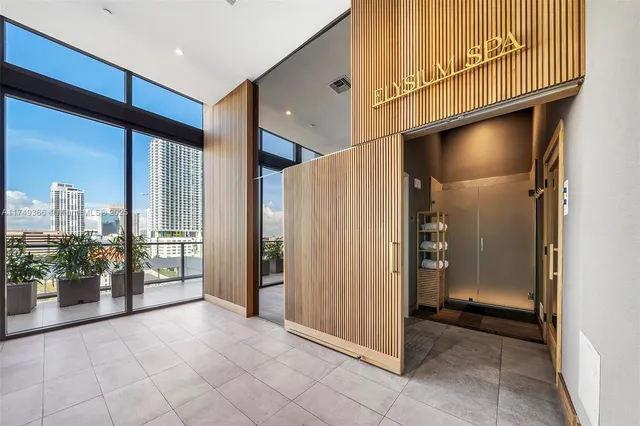 a view of a room with wooden floor and cabinets