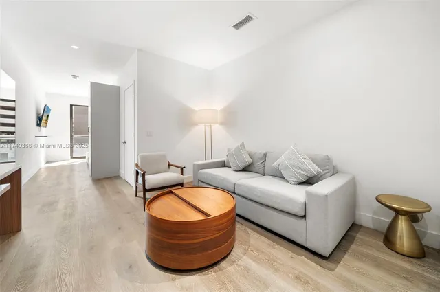 a living room with furniture and a mirror