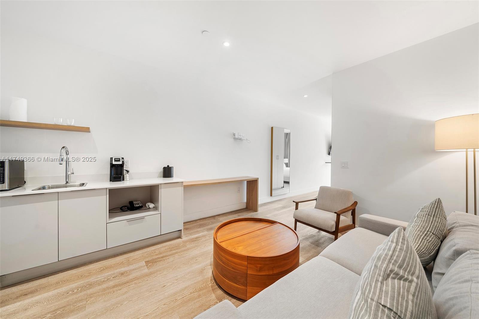 229 Southwest 9th Street, Unit 208 Miami, FL 33130 - Photo 5 of 22 a living room with furniture and a wooden floor