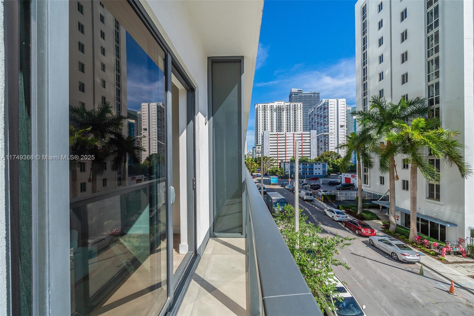 229 Southwest 9th Street, Unit 208 Miami, FL 33130 - Photo 7 of 22 a view of a balcony with chairs and potted plants