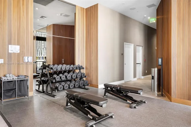 a room with gym equipment and a large mirror