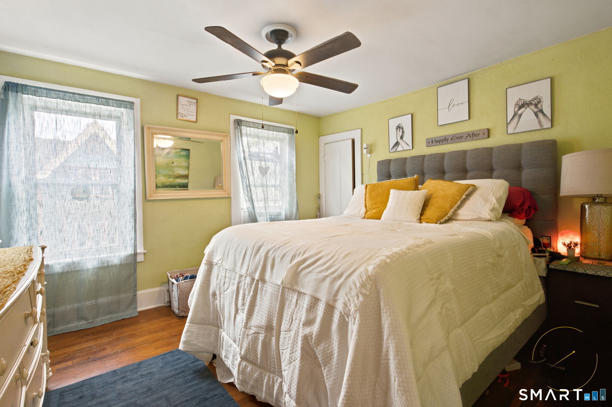 182 Broad Street Norwich, CT 06360 - Photo 22 of 30 a bedroom with a bed and wooden floor