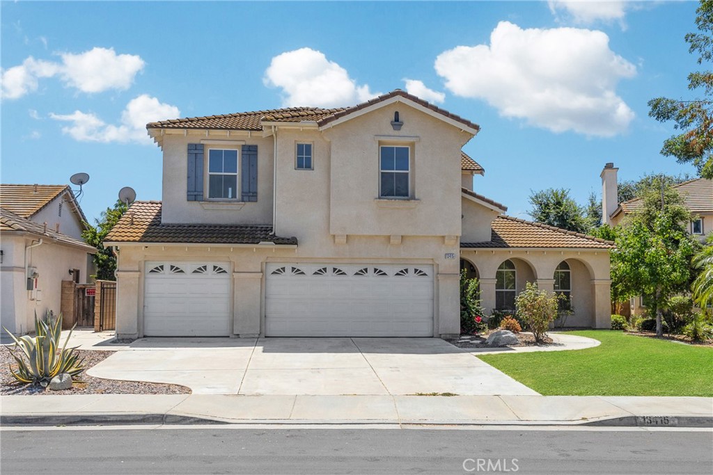 13415 Pheasant Knoll Road Eastvale, CA 92880 - Photo 1 of 1 a front view of a house with a yard and garage