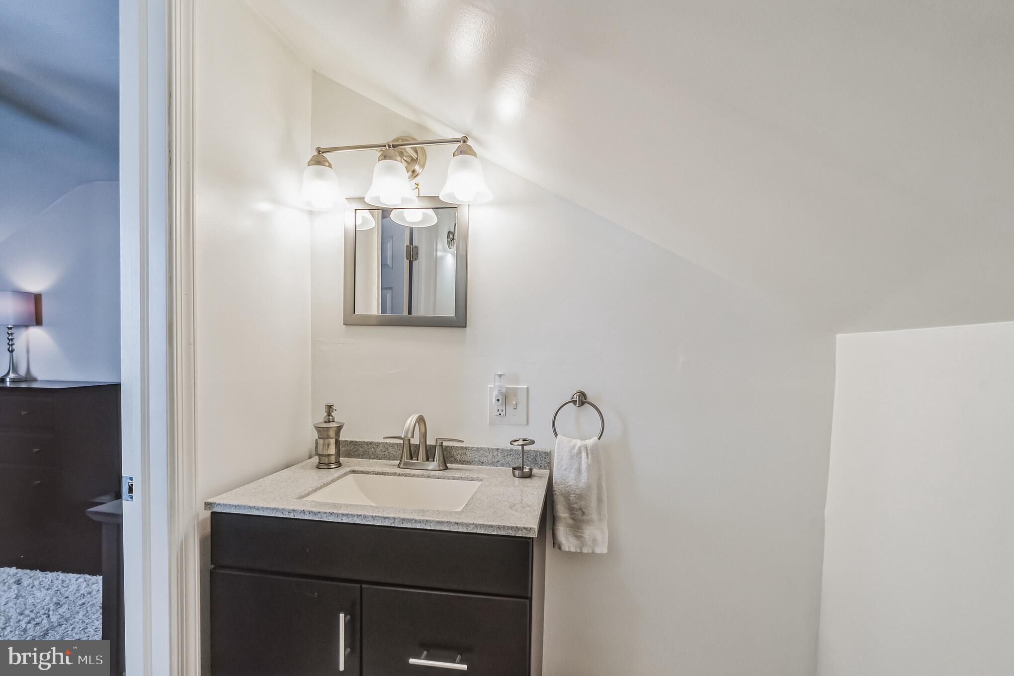 6774 Ridge Avenue, Unit 2 Philadelphia, PA 19128 - Photo 11 of 15 a bathroom with a sink and a mirror