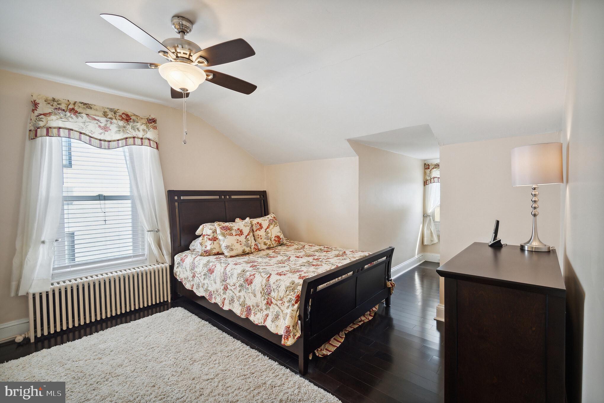 6774 Ridge Avenue, Unit 2 Philadelphia, PA 19128 - Photo 13 of 15 a bedroom with a bed chandelier and a window