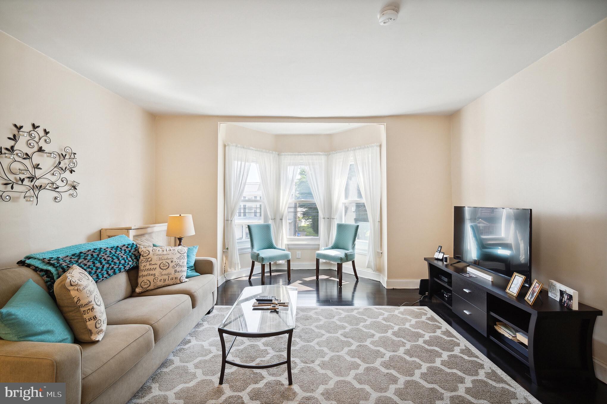 6774 Ridge Avenue, Unit 2 Philadelphia, PA 19128 - Photo 7 of 15 a living room with furniture and a flat screen tv