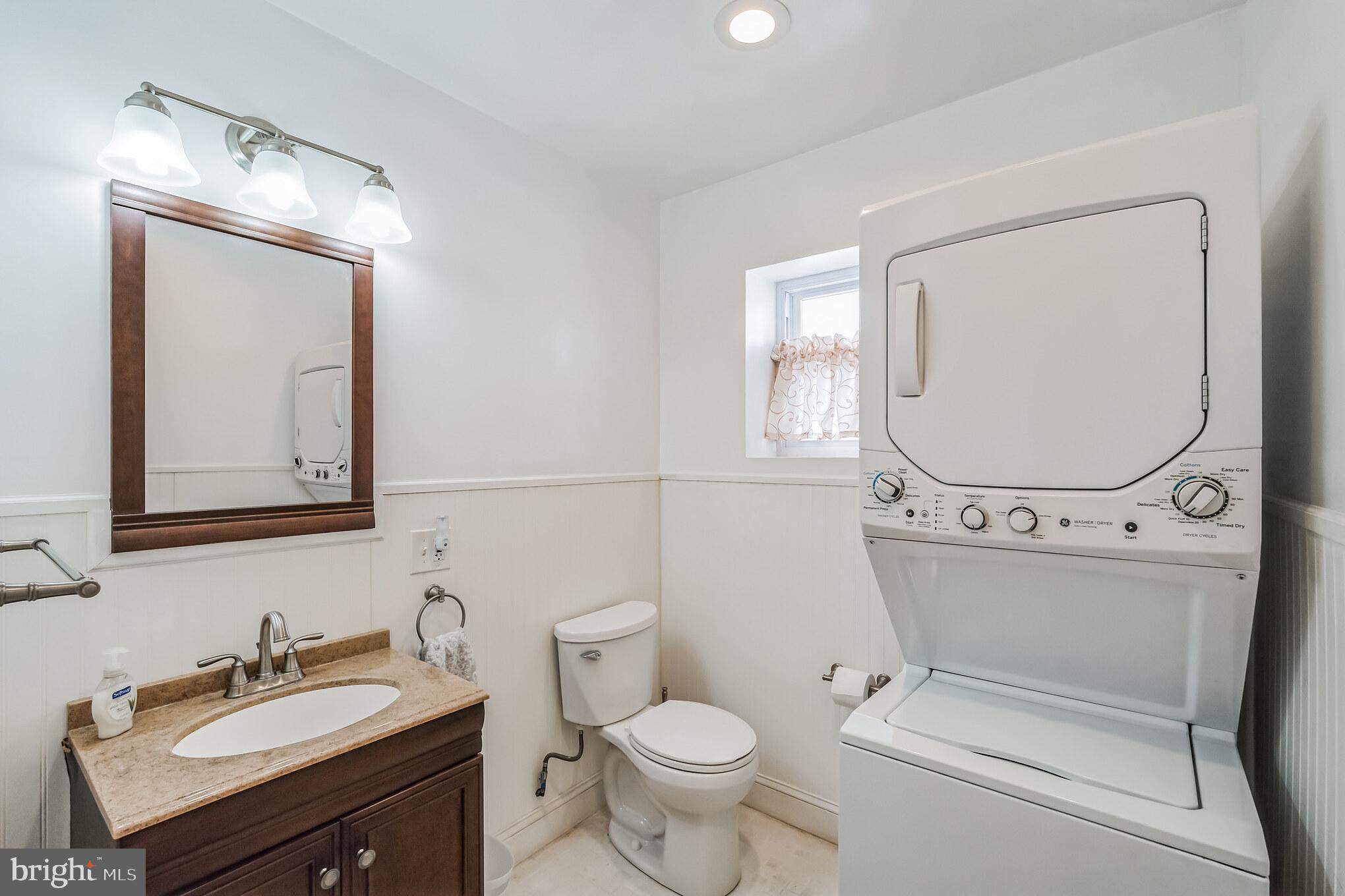 6774 Ridge Avenue, Unit 2 Philadelphia, PA 19128 - Photo 9 of 15 a bathroom with a toilet sink and mirror