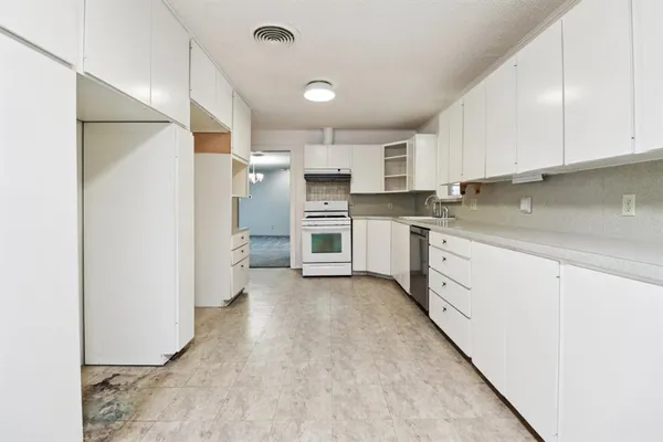 a kitchen with stainless steel appliances granite countertop a refrigerator sink and cabinets