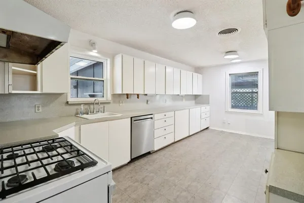 a kitchen with a stove a sink and a microwave