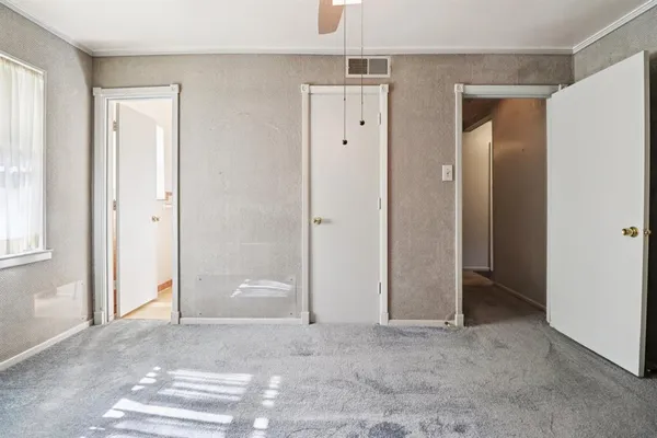 an empty room with windows and closet