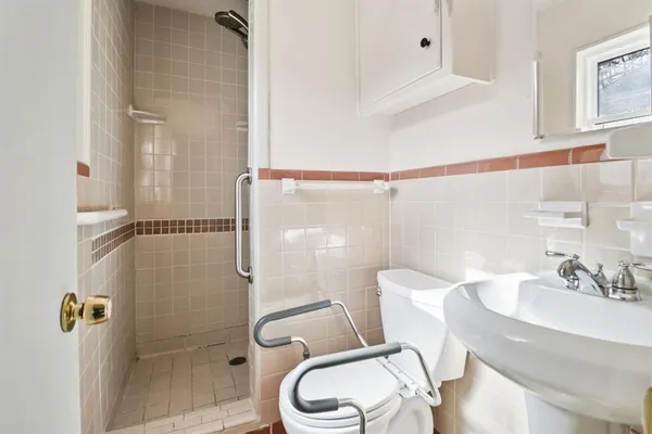 a bathroom with a sink toilet and shower