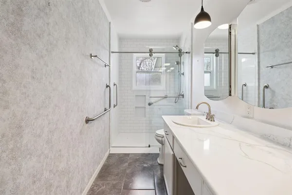 a bathroom with a double vanity sink mirror double and shower