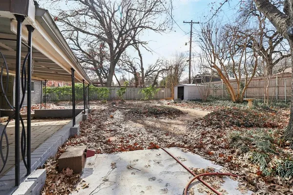 a view of a backyard with large trees