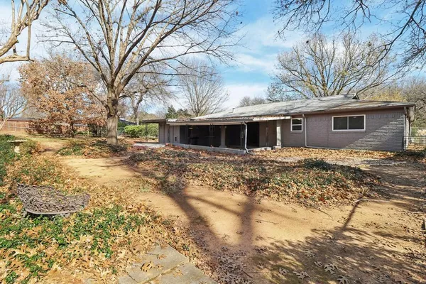 a front view of house with yard covered in snow