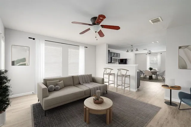 a living room with furniture a rug and a chandelier