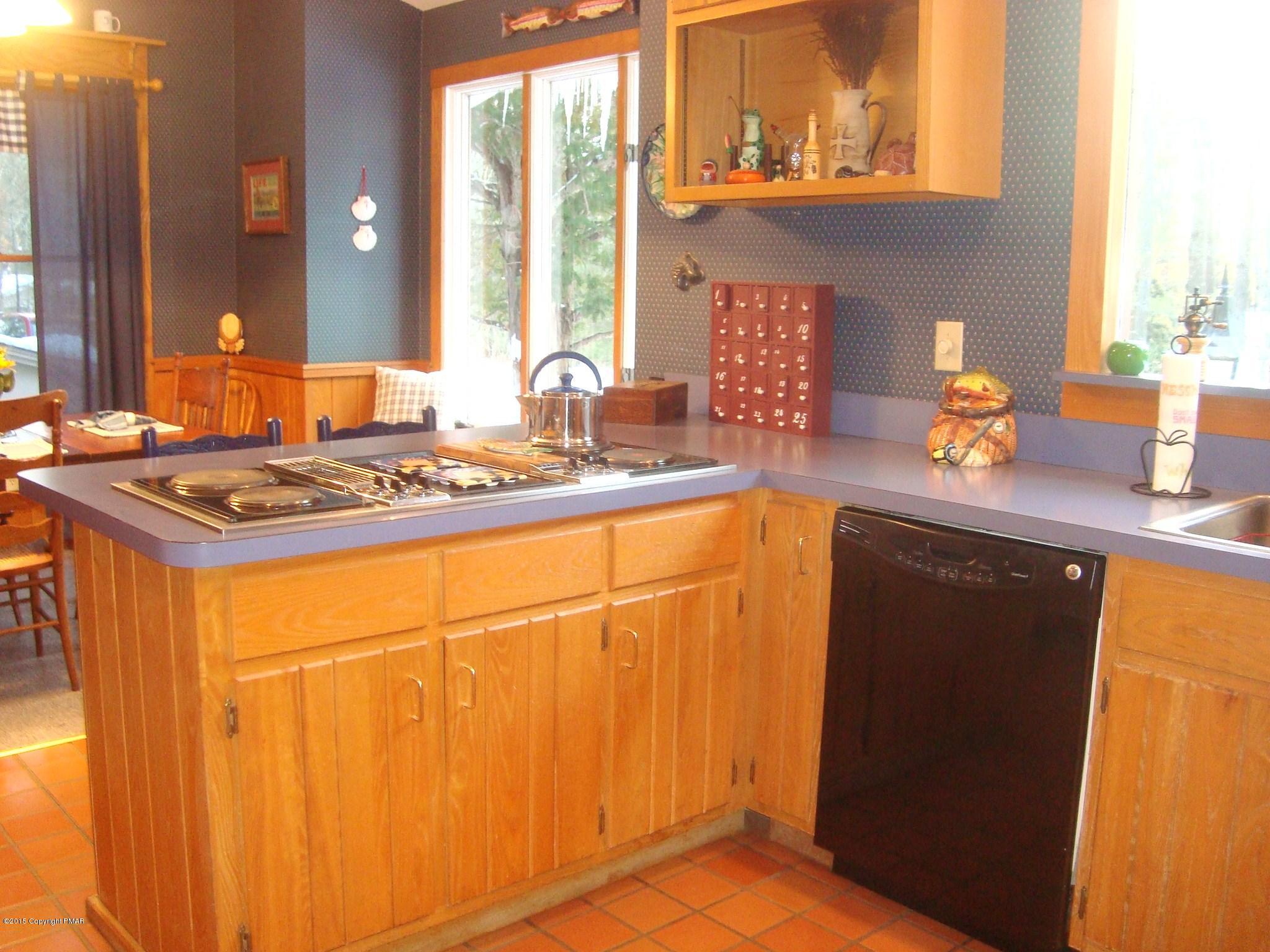 879 Lower Swiftwater Road Cresco, PA 18326 - Photo 13 of 65 a kitchen with stainless steel appliances granite countertop a sink stove and cabinets