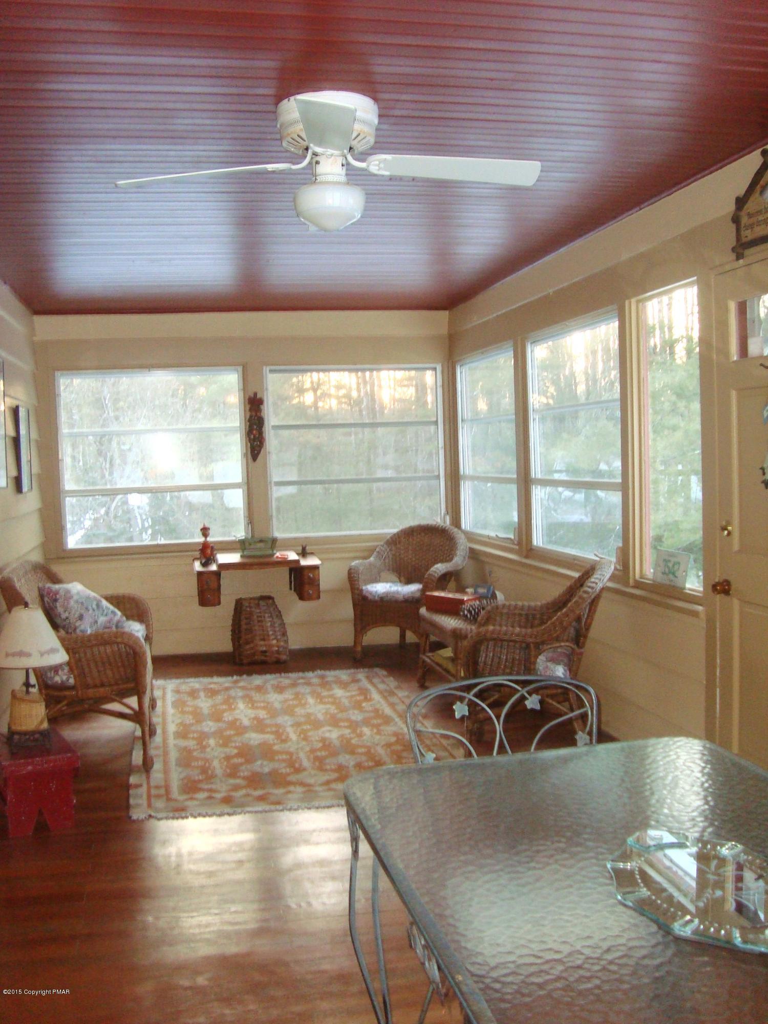 879 Lower Swiftwater Road Cresco, PA 18326 - Photo 21 of 65 a living room with furniture fireplace and large windows