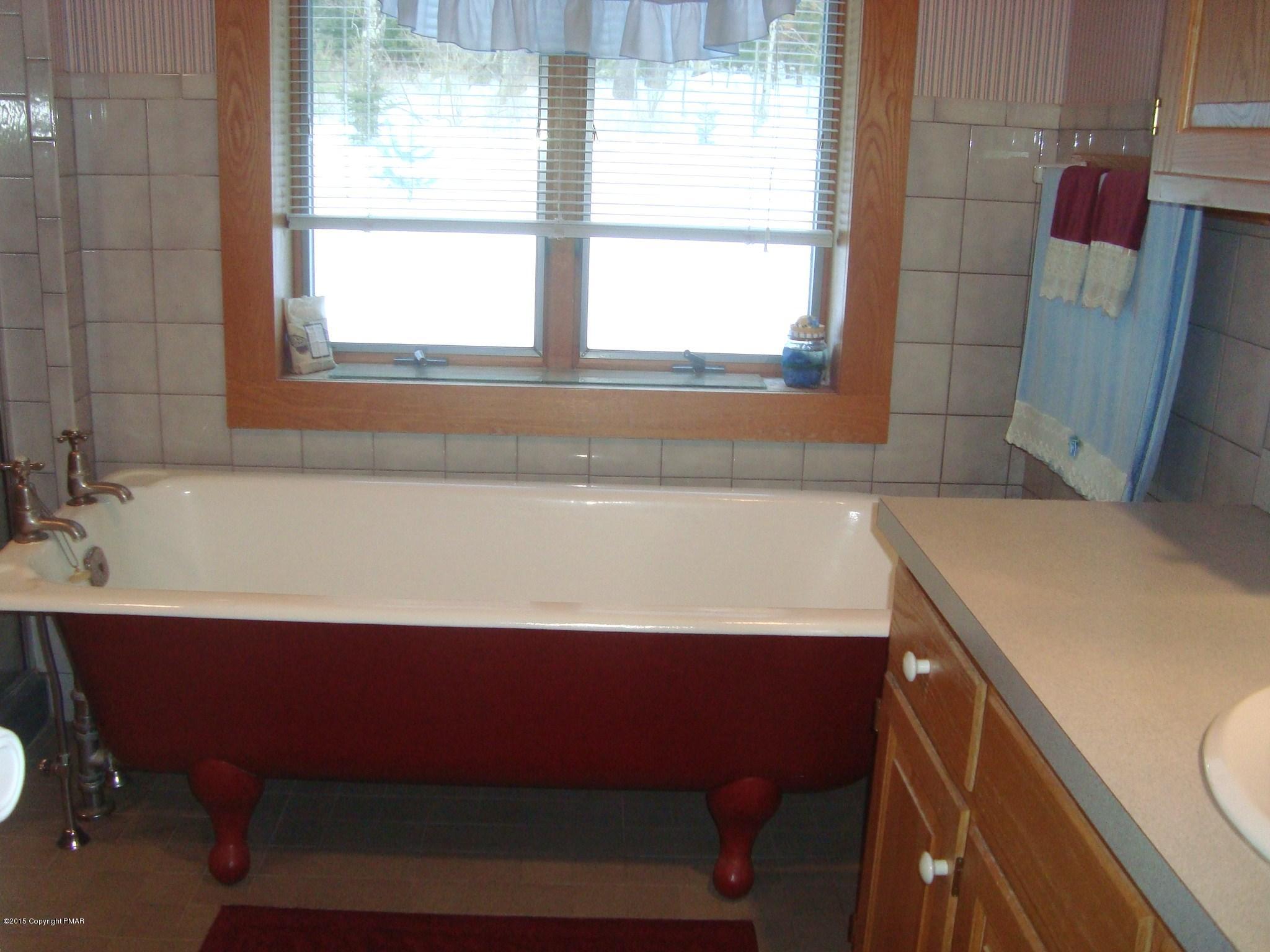 879 Lower Swiftwater Road Cresco, PA 18326 - Photo 29 of 65 a bathroom with a sink and a bathtub
