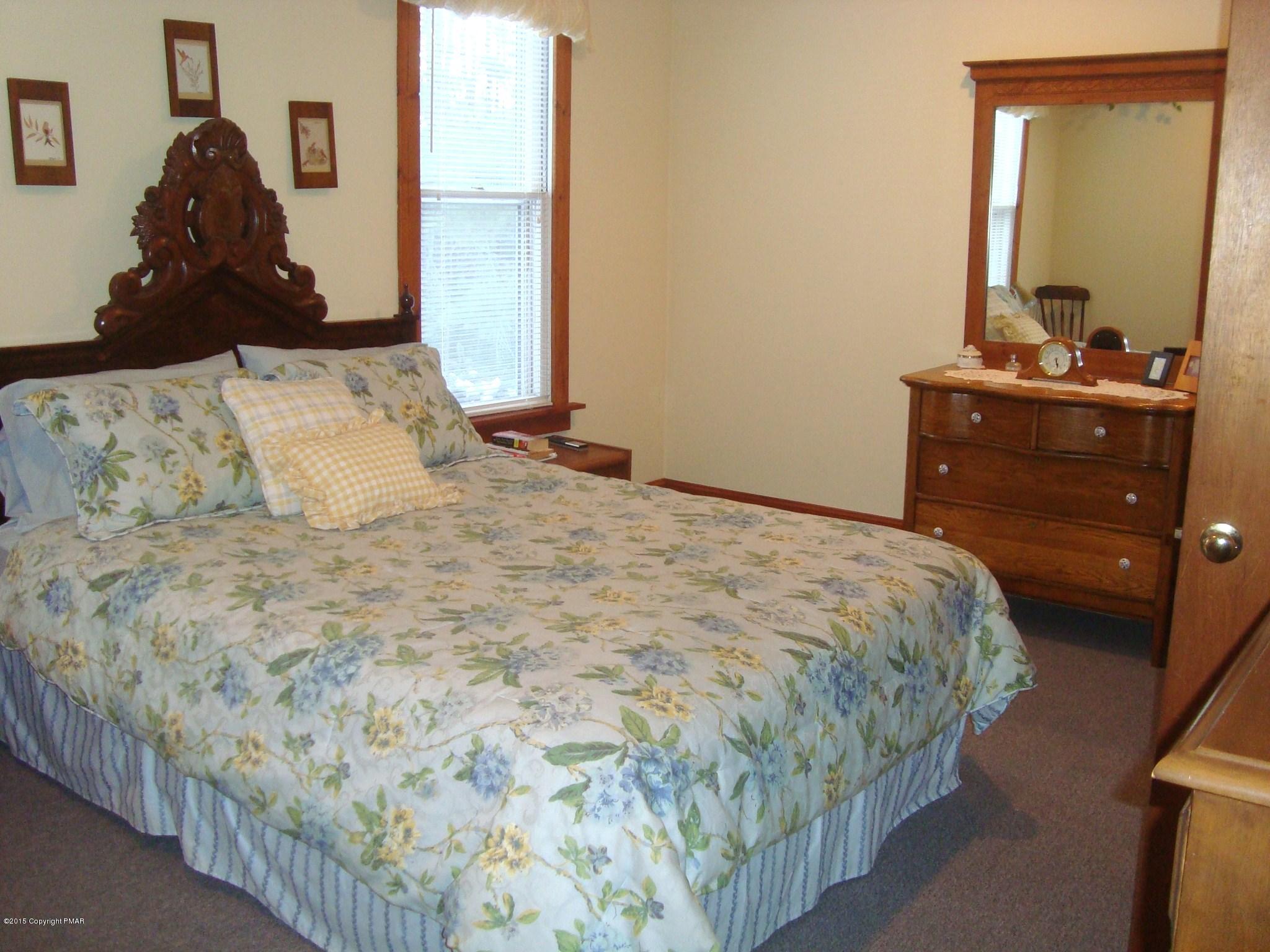 879 Lower Swiftwater Road Cresco, PA 18326 - Photo 34 of 65 a bedroom with a bed and a mirror