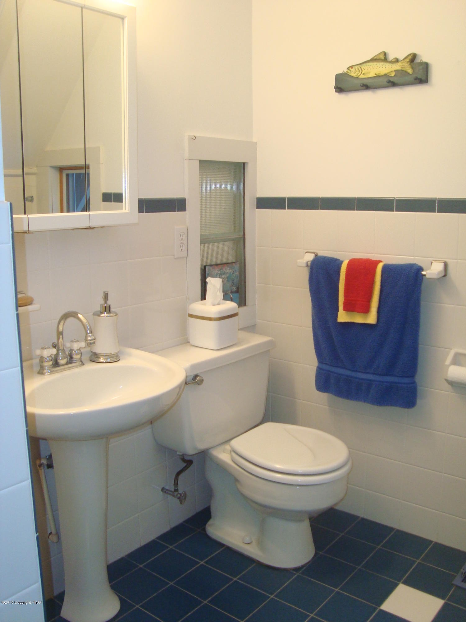 879 Lower Swiftwater Road Cresco, PA 18326 - Photo 45 of 65 a bathroom with a toilet a sink and mirror