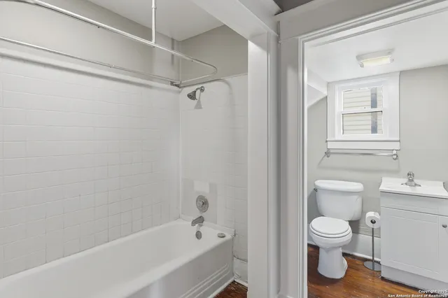 a view of a room with wooden floor