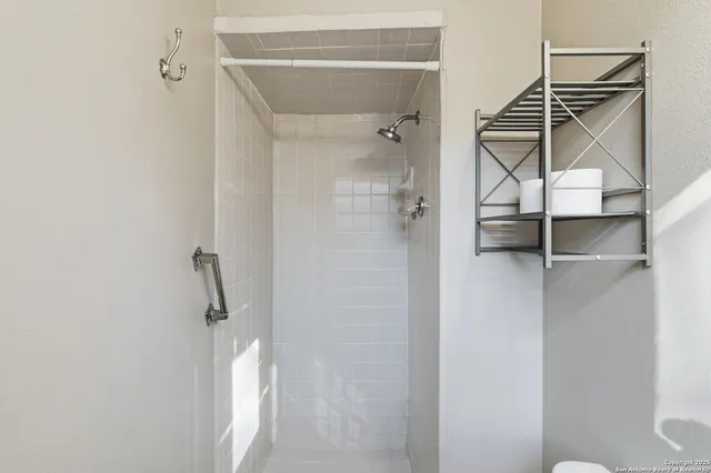 a bathroom with a shower and a sink
