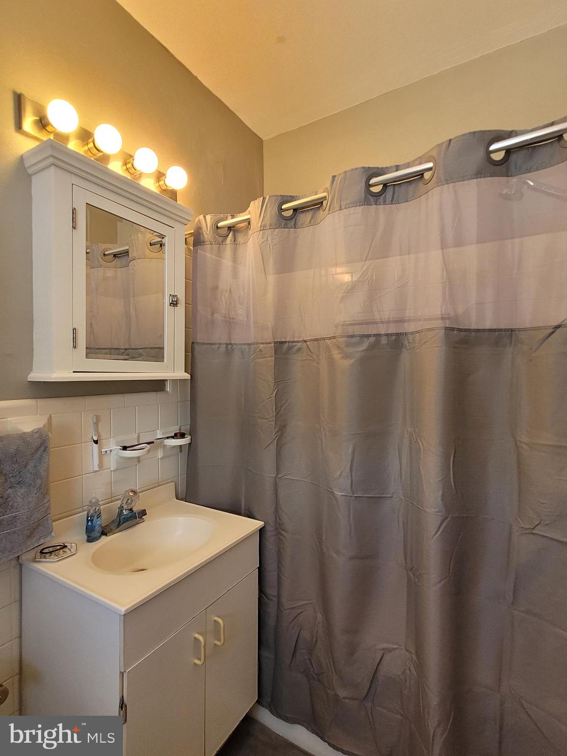2031 Locust Street, Unit 802 Philadelphia, PA 19103 - Photo 12 of 26 a bathroom with a sink and a mirror
