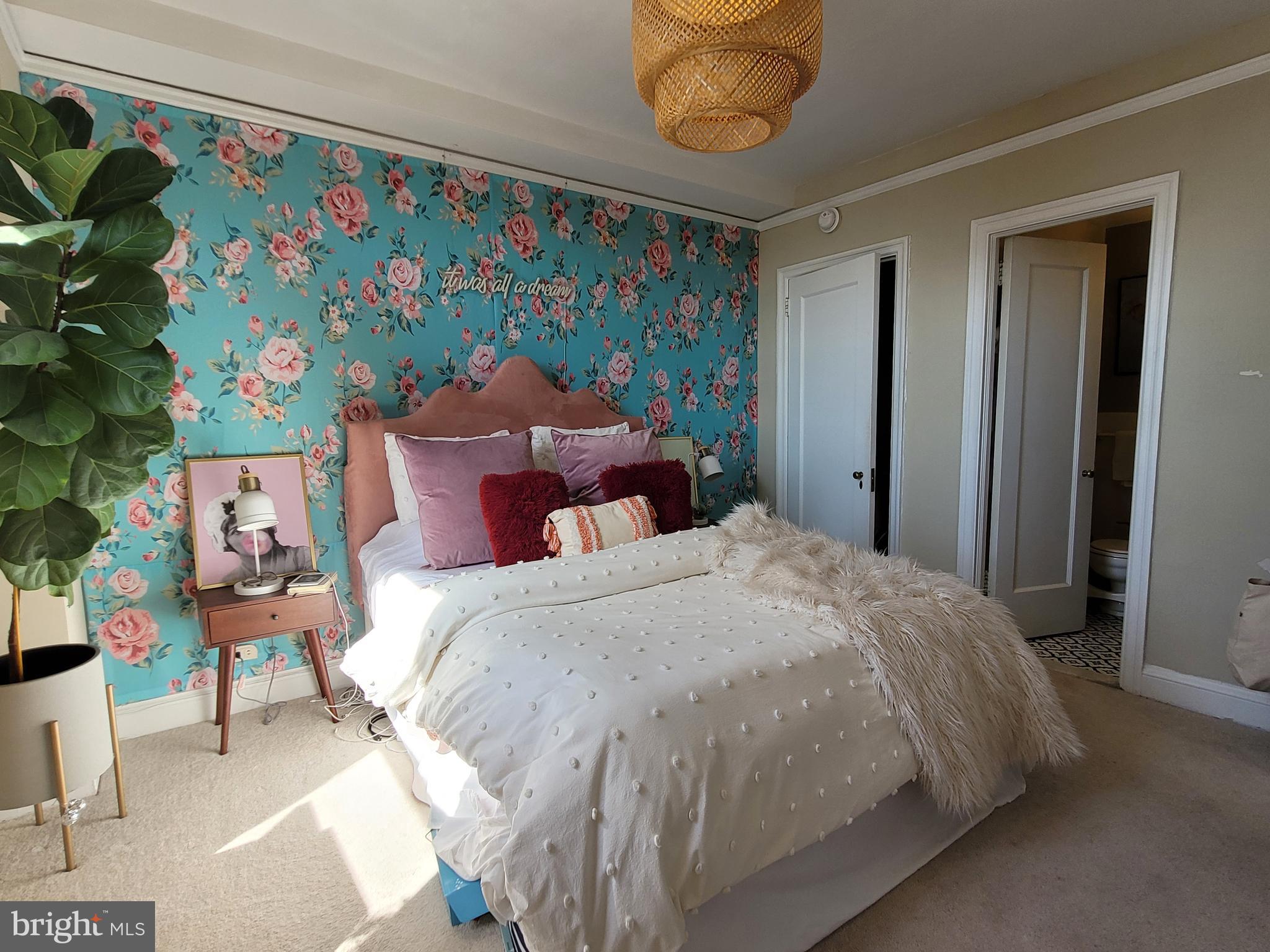 2031 Locust Street, Unit 802 Philadelphia, PA 19103 - Photo 14 of 26 a bedroom with a bed and a painting on the wall