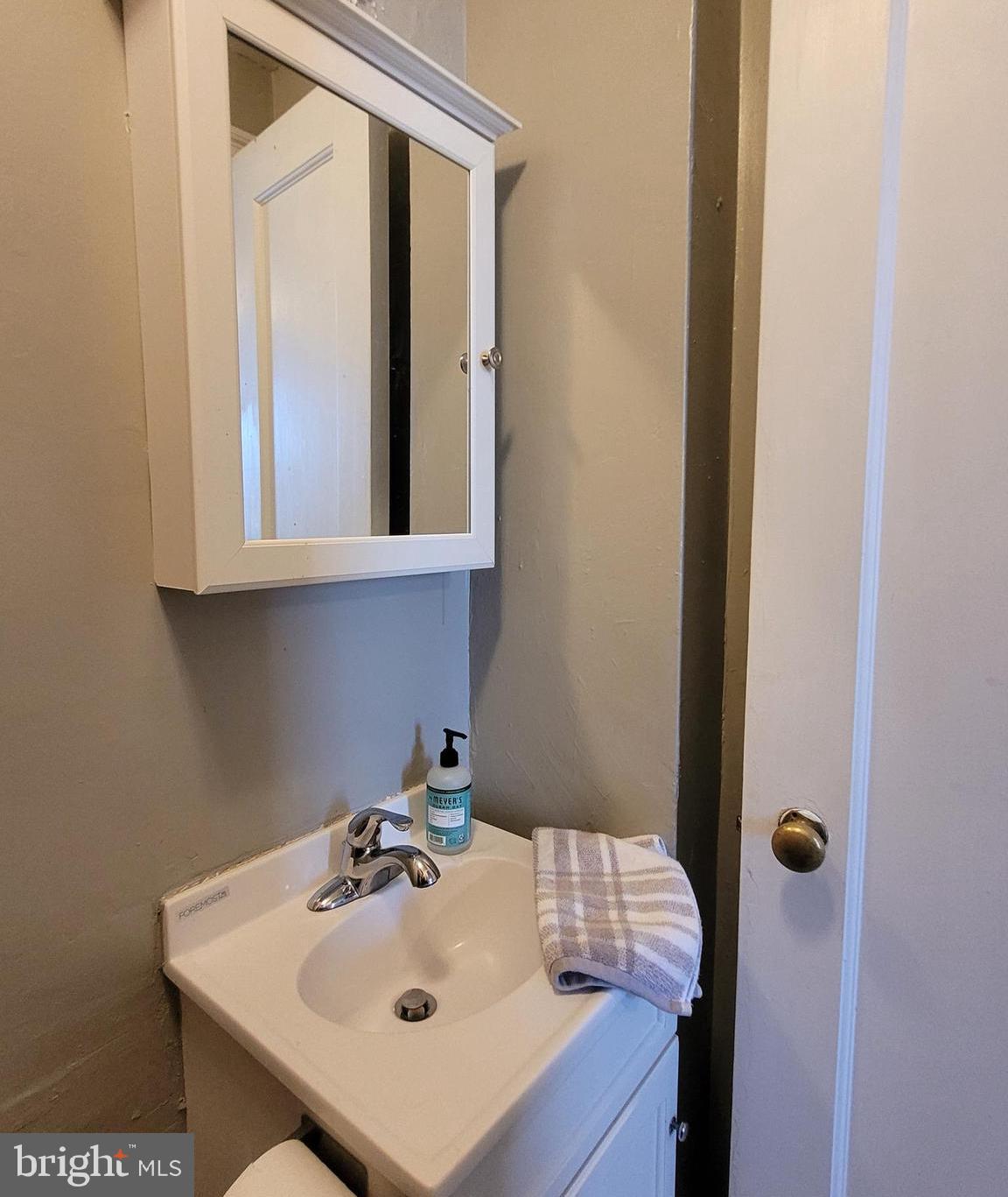 2031 Locust Street, Unit 802 Philadelphia, PA 19103 - Photo 17 of 26 a bathroom with a sink and cabinets