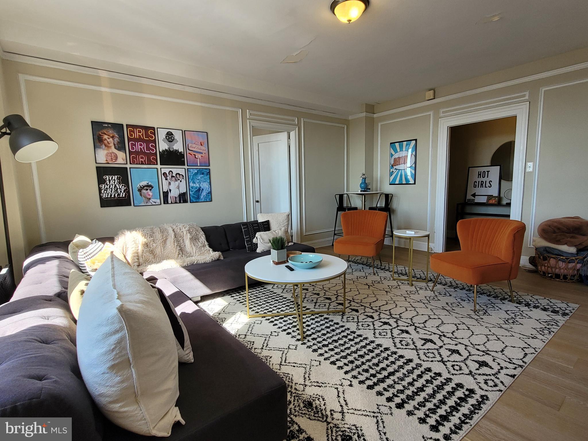2031 Locust Street, Unit 802 Philadelphia, PA 19103 - Photo 4 of 26 a living room with furniture and painting on the wall