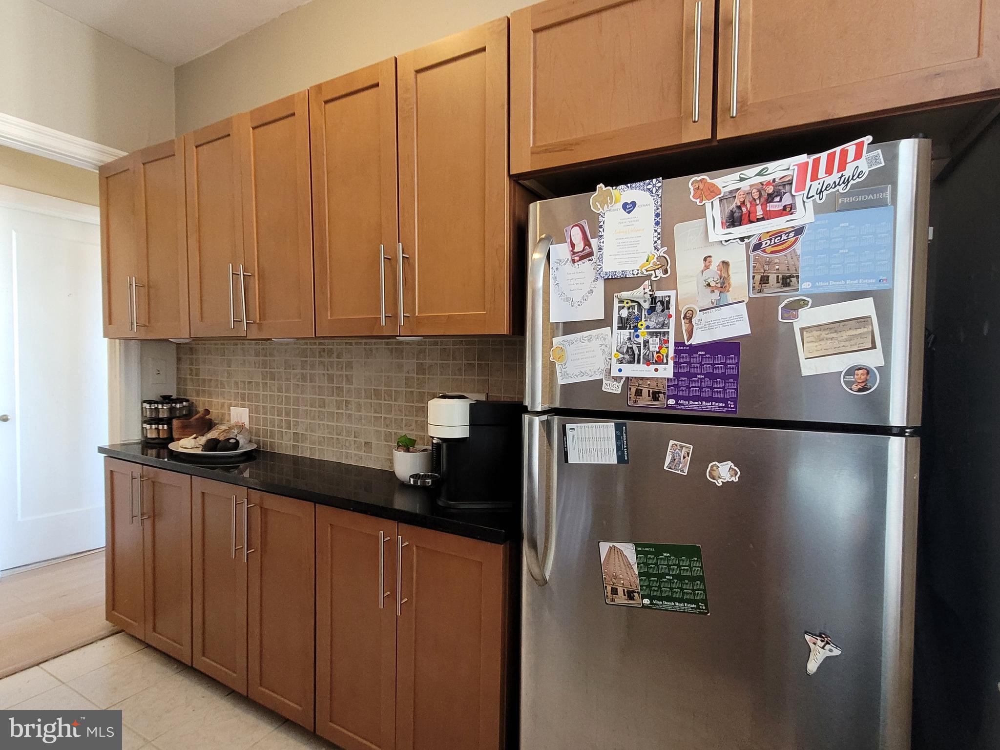 2031 Locust Street, Unit 802 Philadelphia, PA 19103 - Photo 7 of 26 a view of a refrigerator a sink and cabinets
