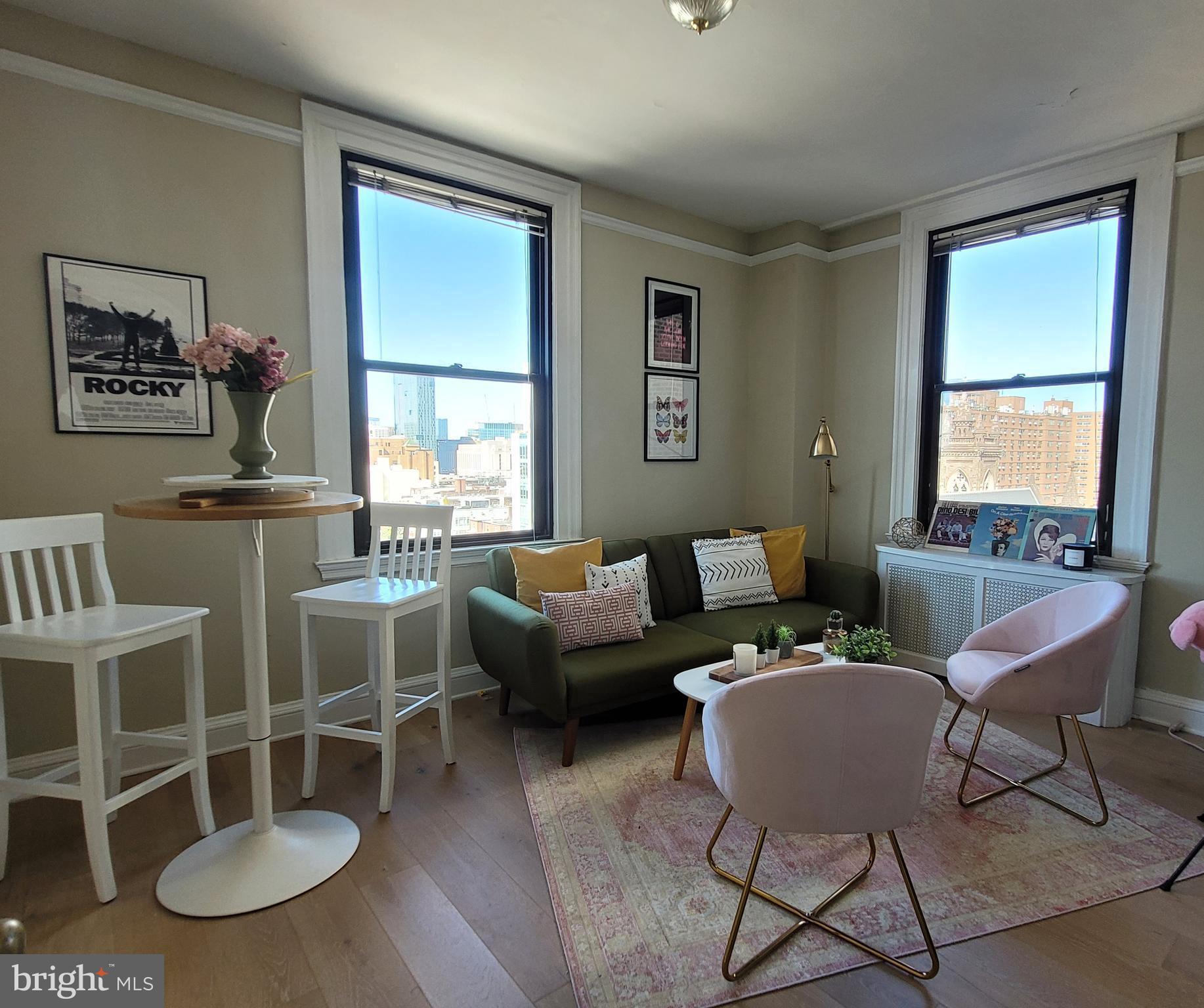 2031 Locust Street, Unit 802 Philadelphia, PA 19103 - Photo 8 of 26 a living room with furniture a table and a window