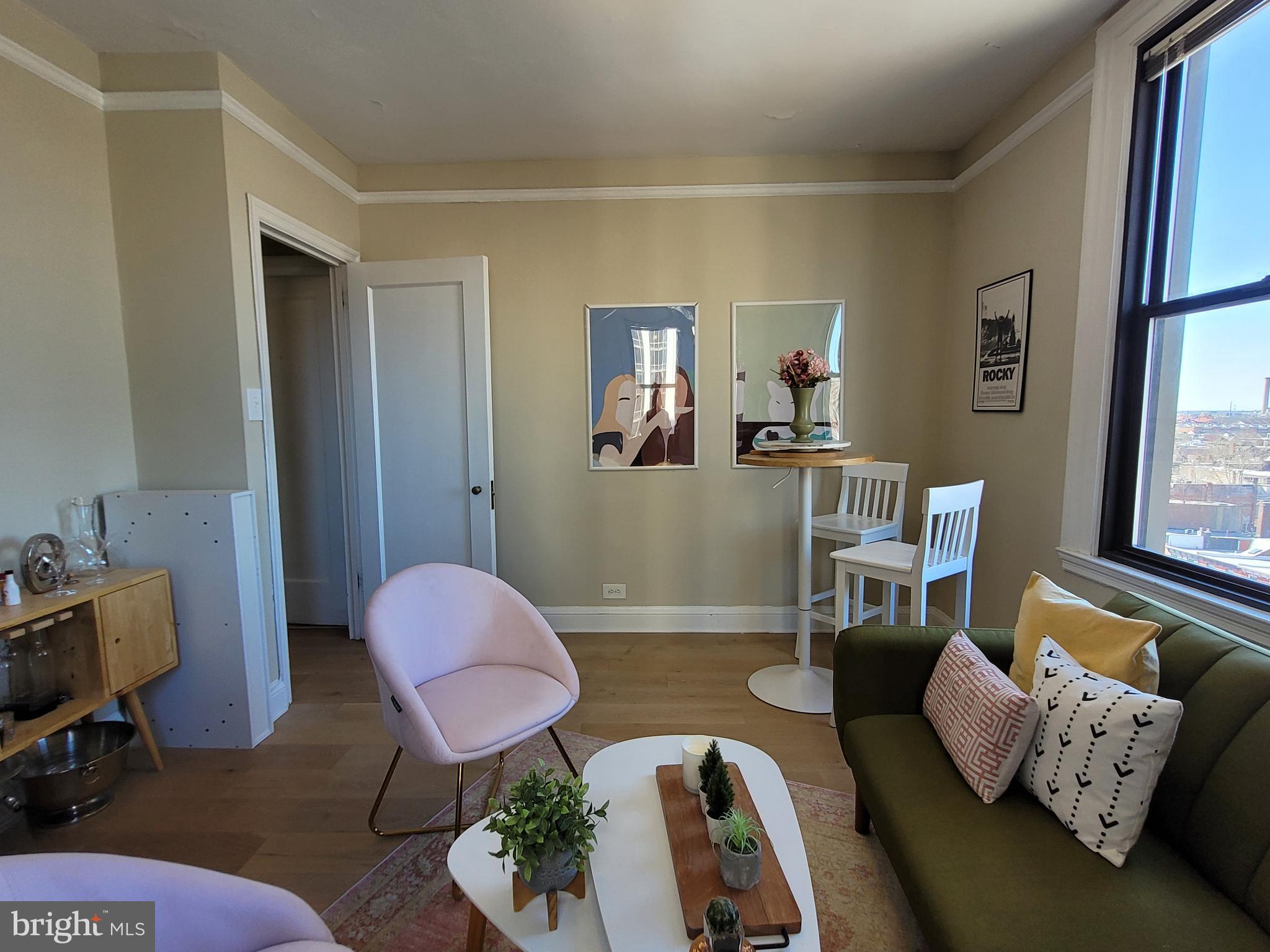 2031 Locust Street, Unit 802 Philadelphia, PA 19103 - Photo 9 of 26 a living room with furniture and wooden floor