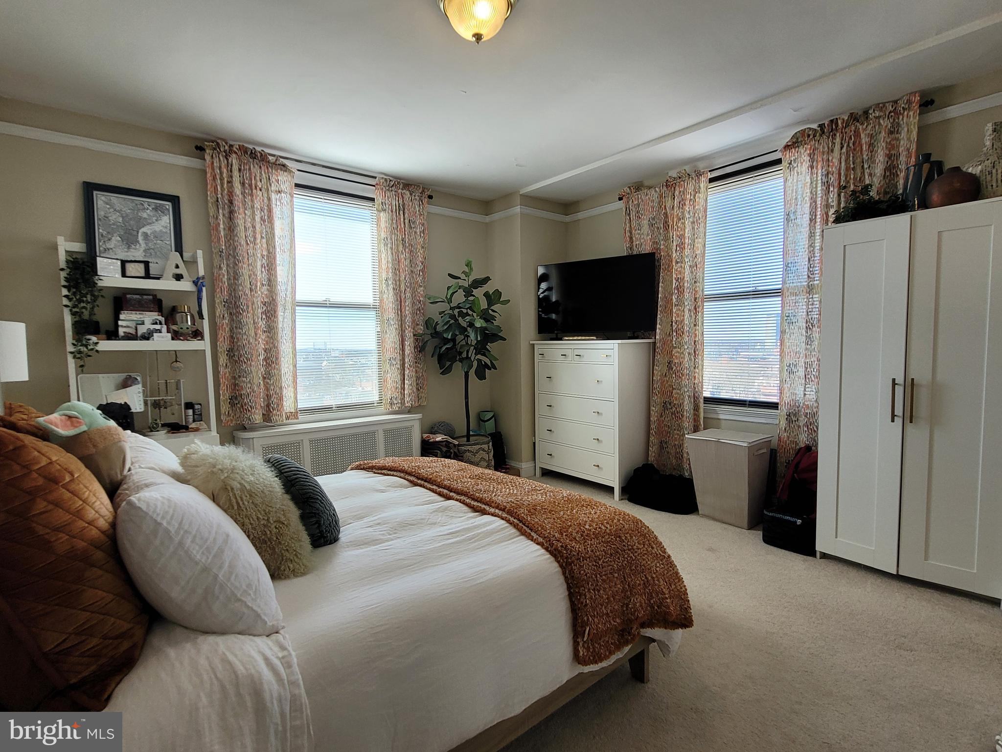 2031 Locust Street, Unit 802 Philadelphia, PA 19103 - Photo 10 of 26 a bedroom with a bed a couch and a window