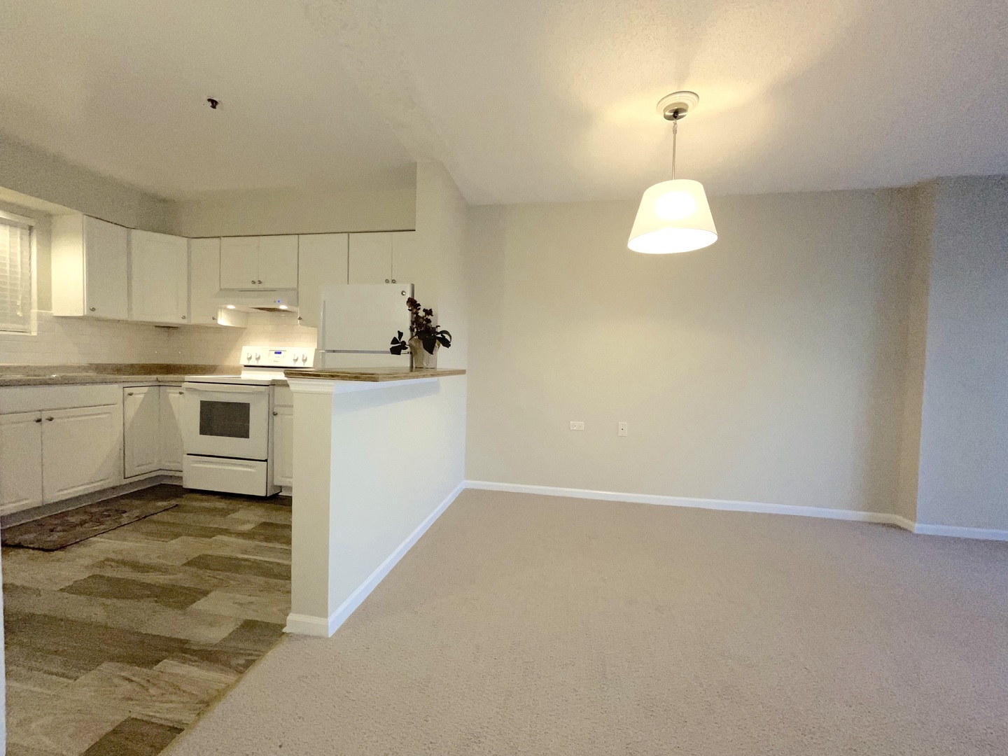 800 Ridge Road, Unit 204 Wilmette, IL 60091 - Photo 2 of 10 a kitchen with kitchen island granite countertop appliances and cabinets