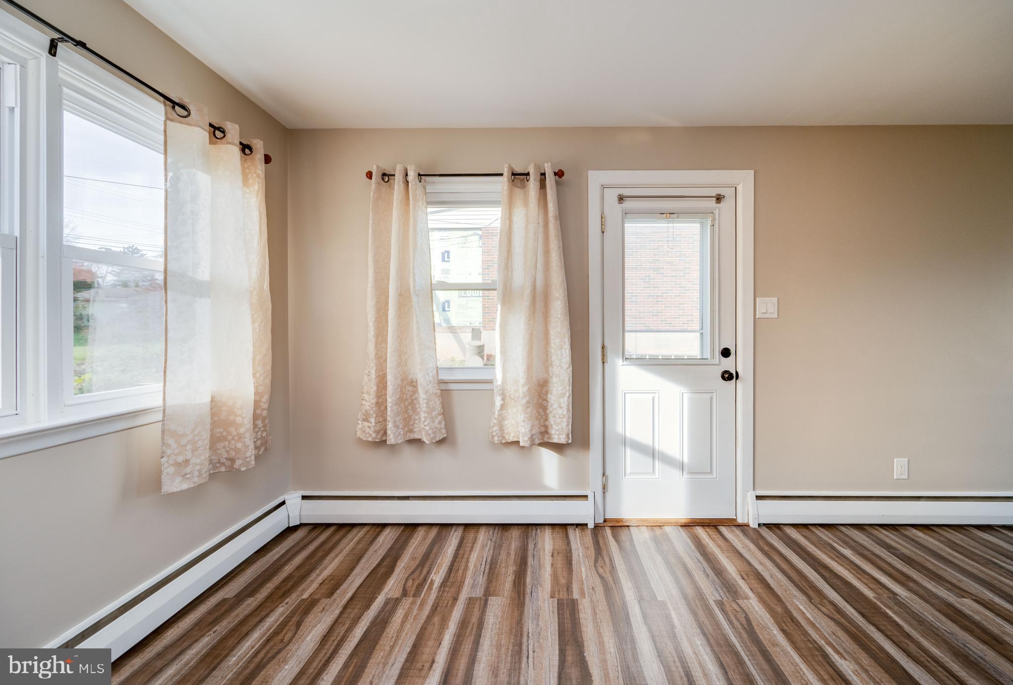 3346 Sheidy Avenue Reading, PA 19605 - Photo 11 of 35 a view of an empty room with wooden floor and a window