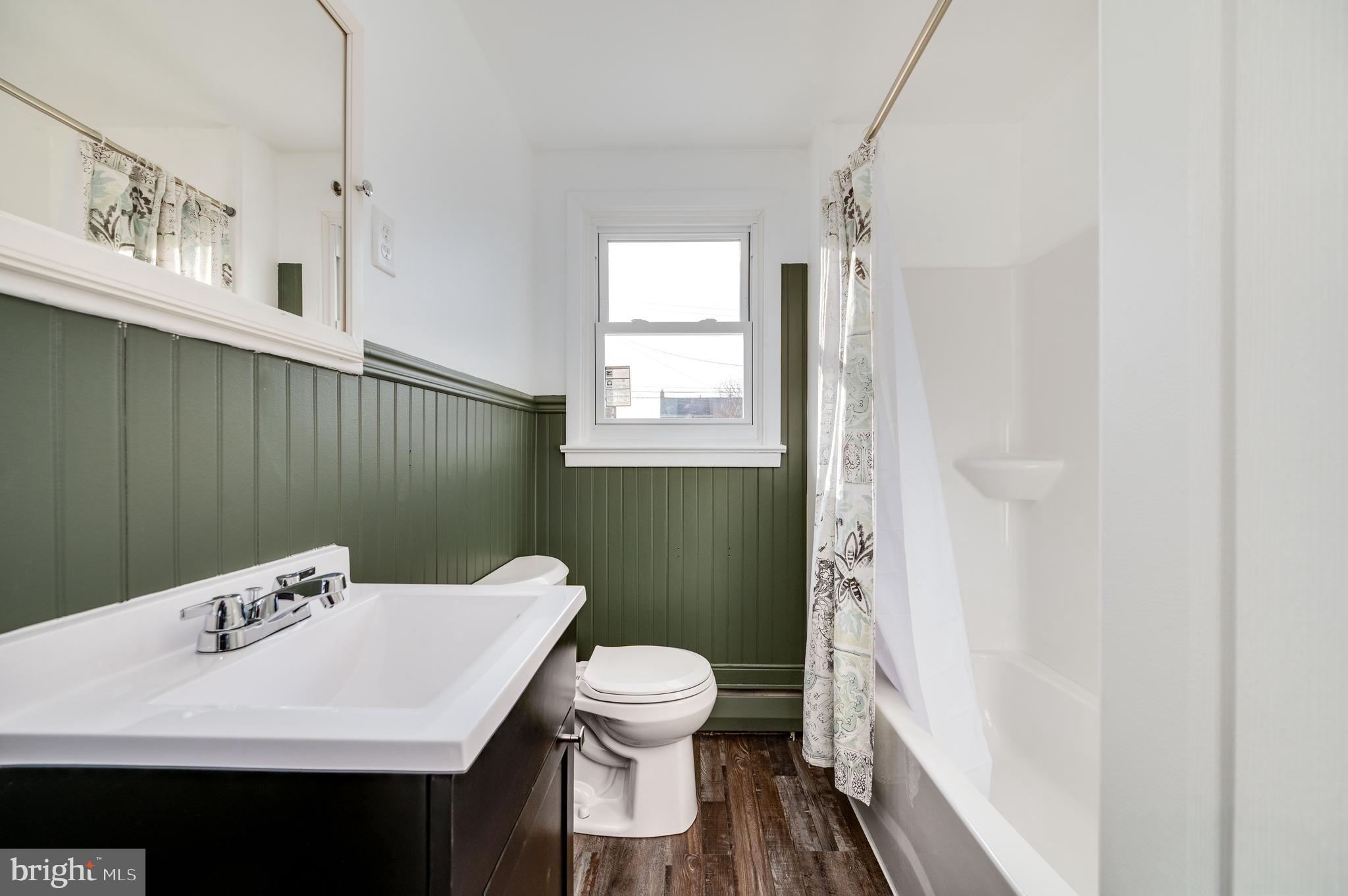 3346 Sheidy Avenue Reading, PA 19605 - Photo 12 of 35 a bathroom with a sink a toilet and a mirror