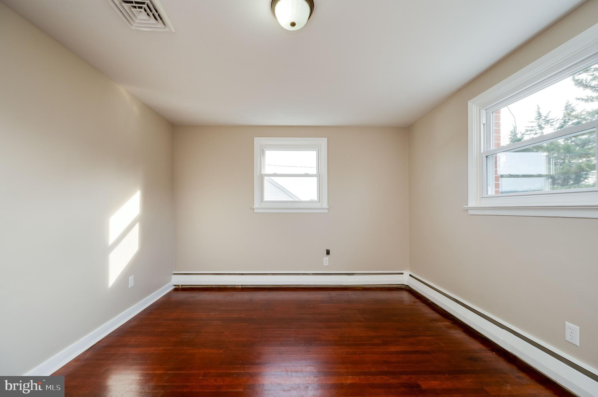 3346 Sheidy Avenue Reading, PA 19605 - Photo 14 of 35 an empty room with wooden floor and windows