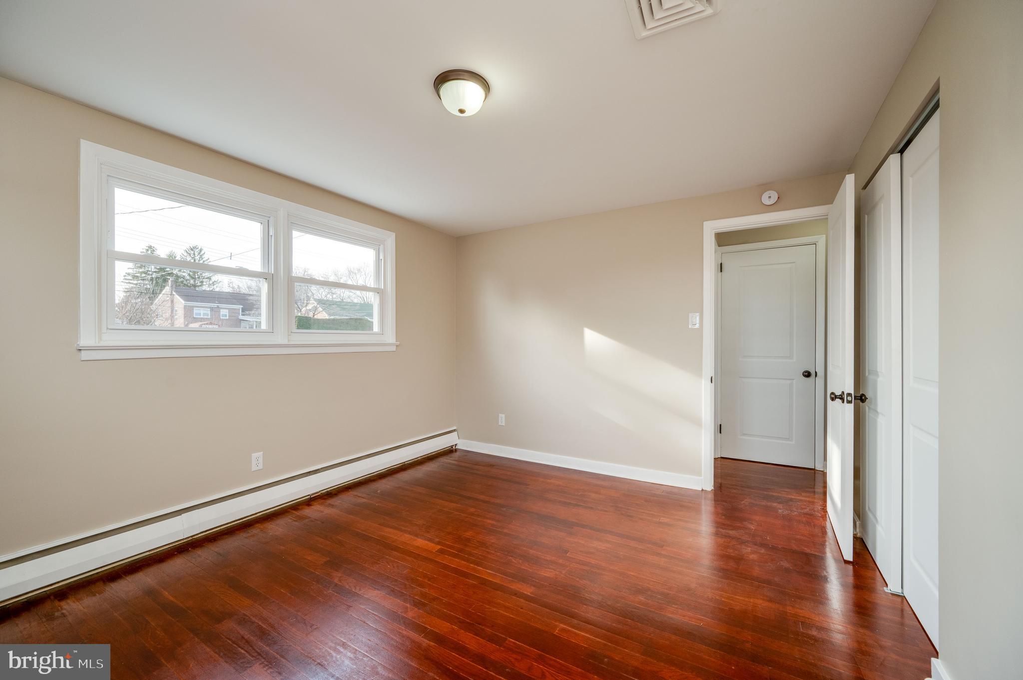 3346 Sheidy Avenue Reading, PA 19605 - Photo 15 of 35 an empty room with wooden floor and windows