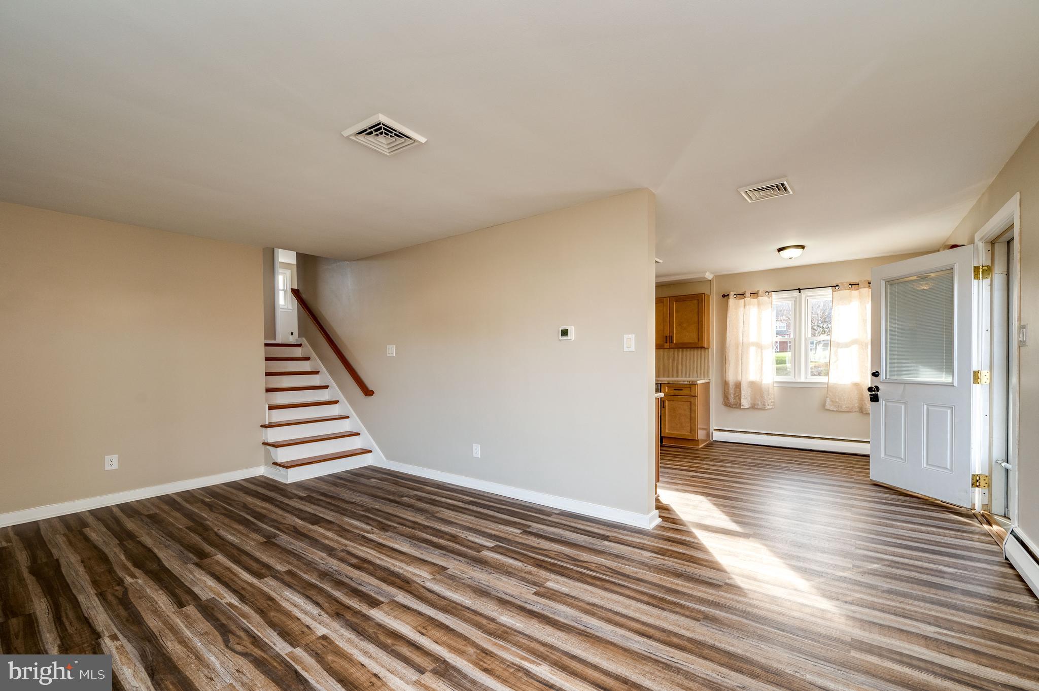 3346 Sheidy Avenue Reading, PA 19605 - Photo 5 of 35 a view of an empty room with wooden floor and a window