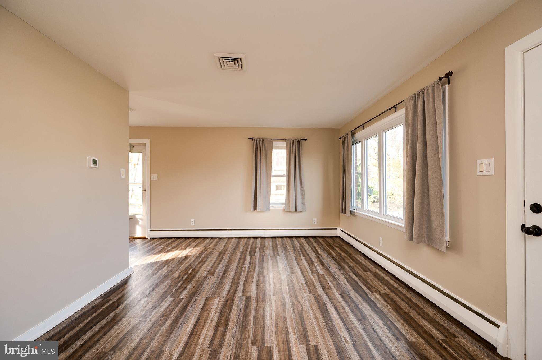 3346 Sheidy Avenue Reading, PA 19605 - Photo 7 of 35 a view of an empty room with glass door and wooden floor