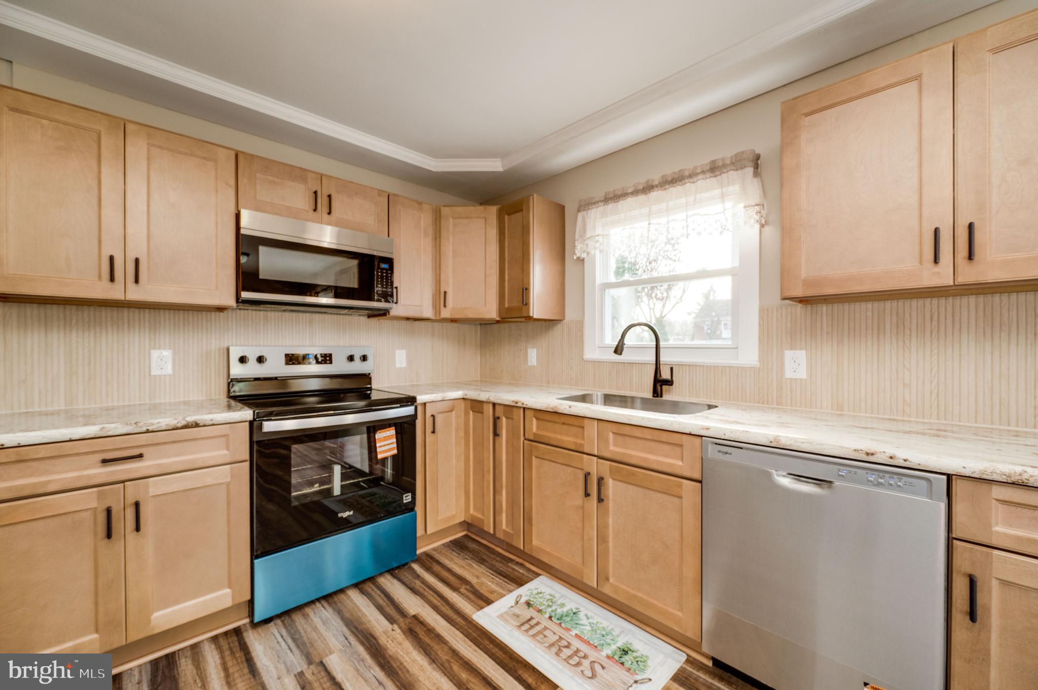 3346 Sheidy Avenue Reading, PA 19605 - Photo 9 of 35 a kitchen with cabinets appliances a sink and a window