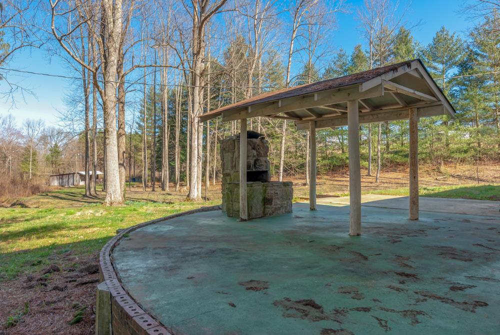 72 Denson Road Lawrenceburg, TN 38464 - Photo 24 of 30 You've got a great concrete patio with a covered area. Stone fireplace might be useable, but owners never used it.