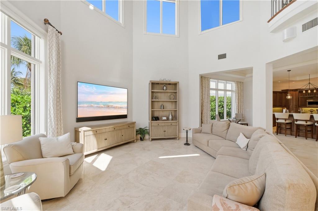 361 Pirates Bight Naples, FL 34103 - Photo 16 of 45 a living room with furniture and a flat screen tv