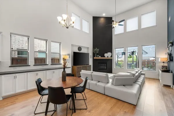 a kitchen with a sink a counter top space stainless steel appliances and wooden floor